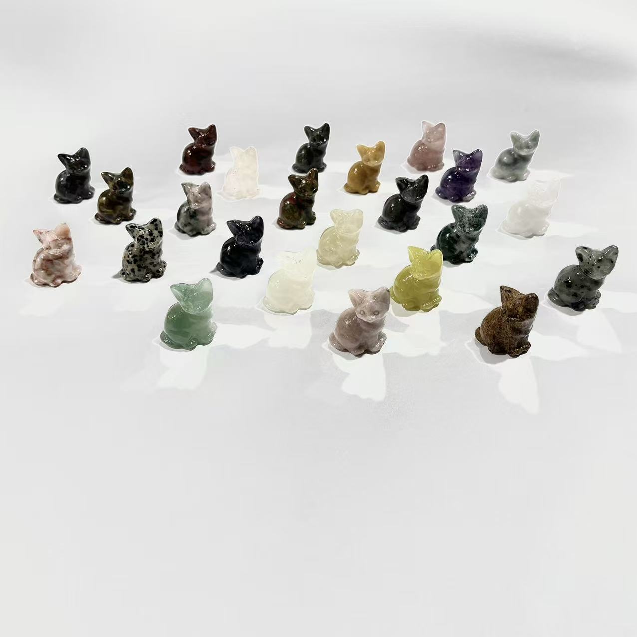 Sitting cats made from various crystal materials