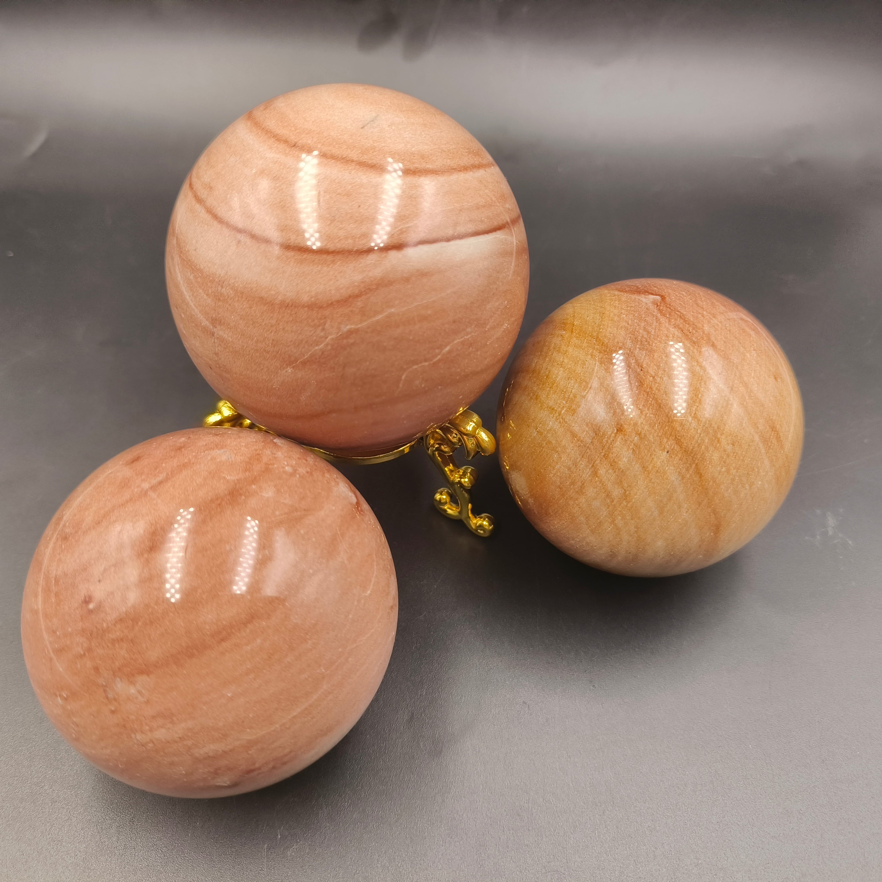 Red woodgrain stone sphere