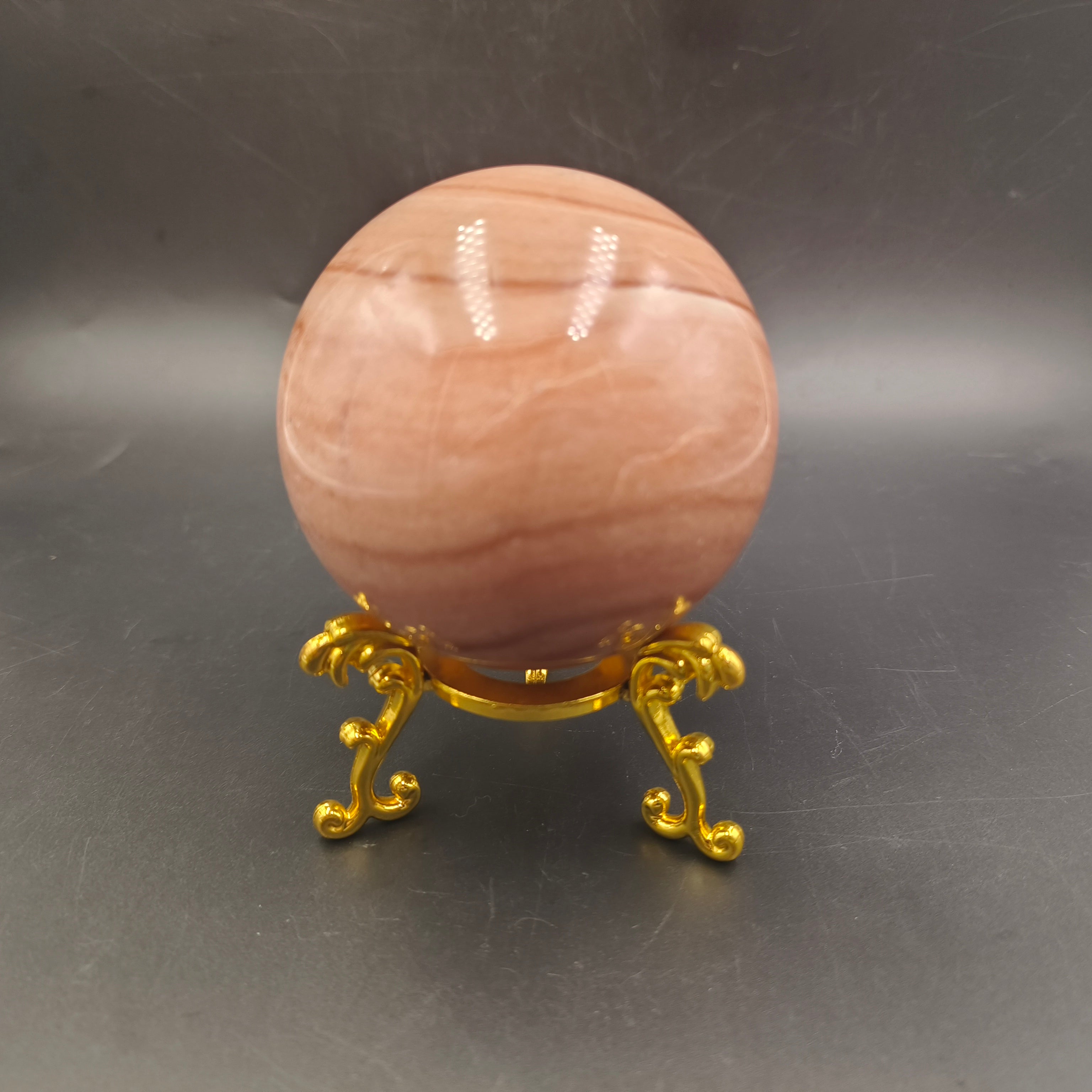 Red woodgrain stone sphere